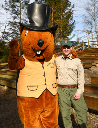 Tyler Evans, wildlife biologist at the Wildlife Center poses with French Creek Freddie costumed mascot