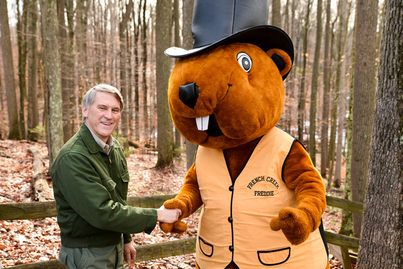 Art Shomo, of the West Virginia DNR shakes hands with the French Creek Freddie costumed mascot